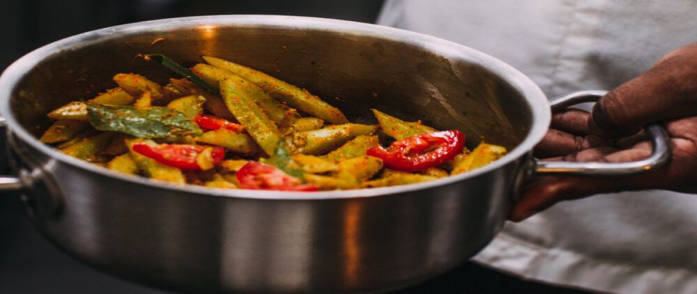 A cook holds a dish.